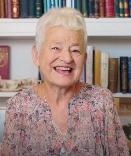 Author Jacqueline Wilson smiling infront of a bookshelf